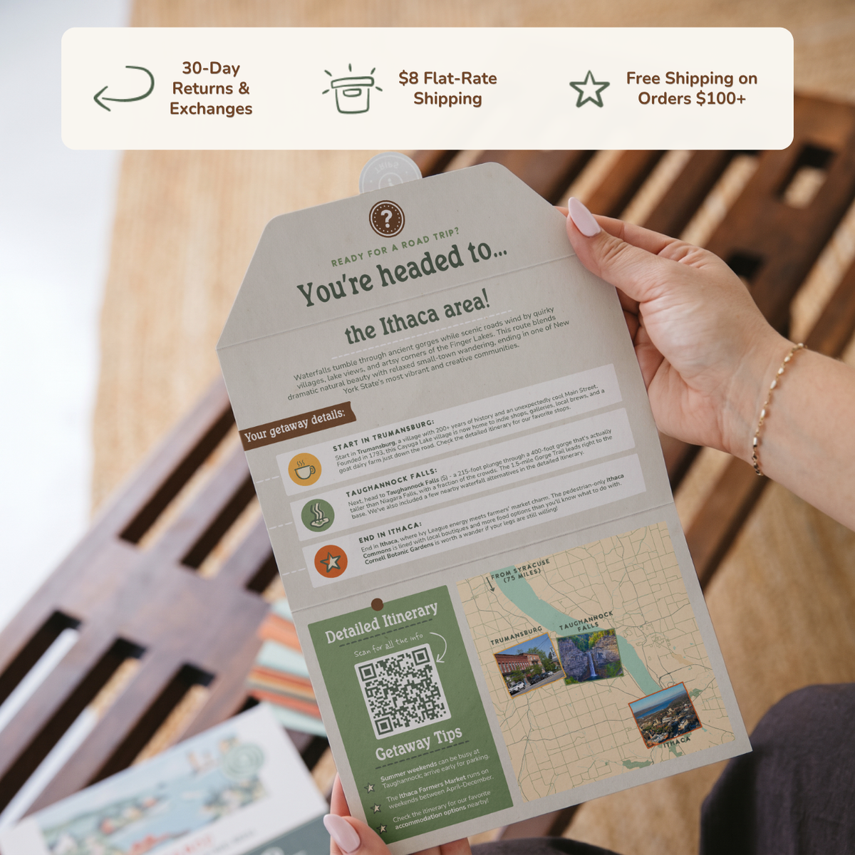 Hands holding an open itinerary card. Banner reads: 30-day returns and exchanges, $8 flat-rate shipping, free shipping on orders $100+.