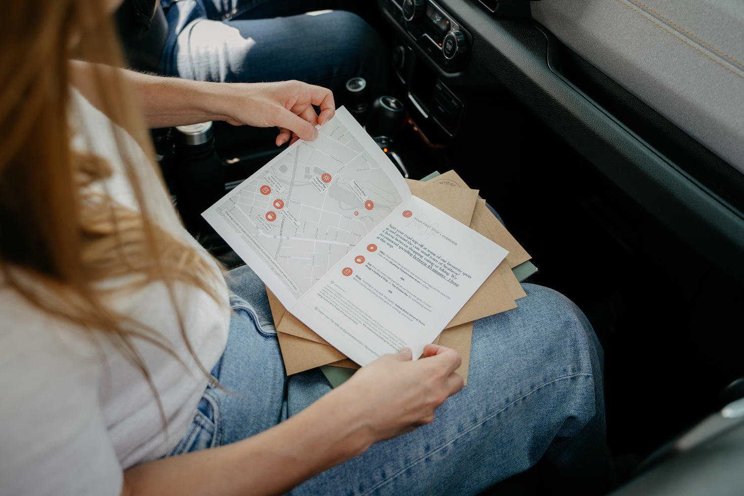 Woman Opening Guess Where Trips Envelope