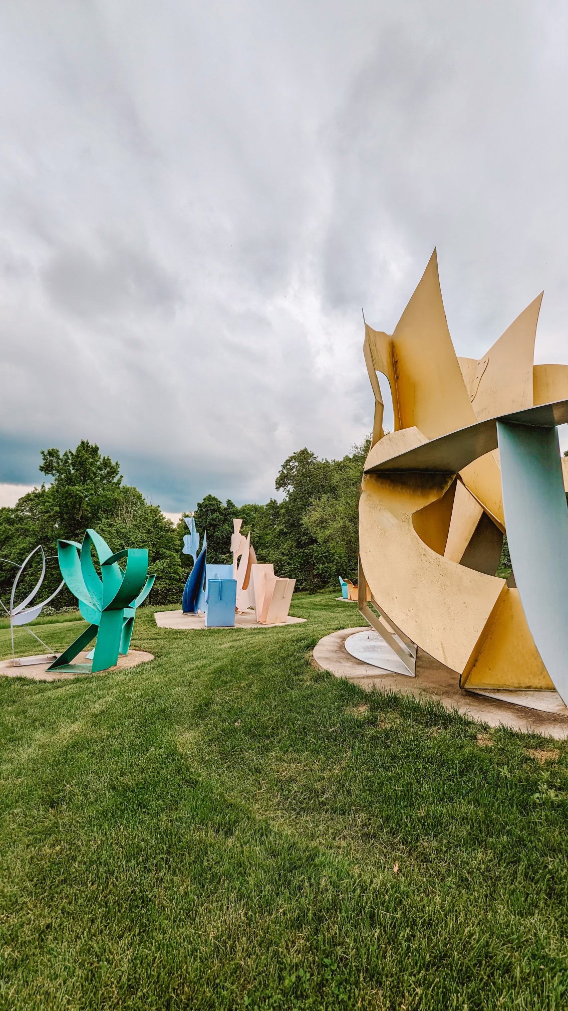 Colourful outdoor sculptures on a lawn.