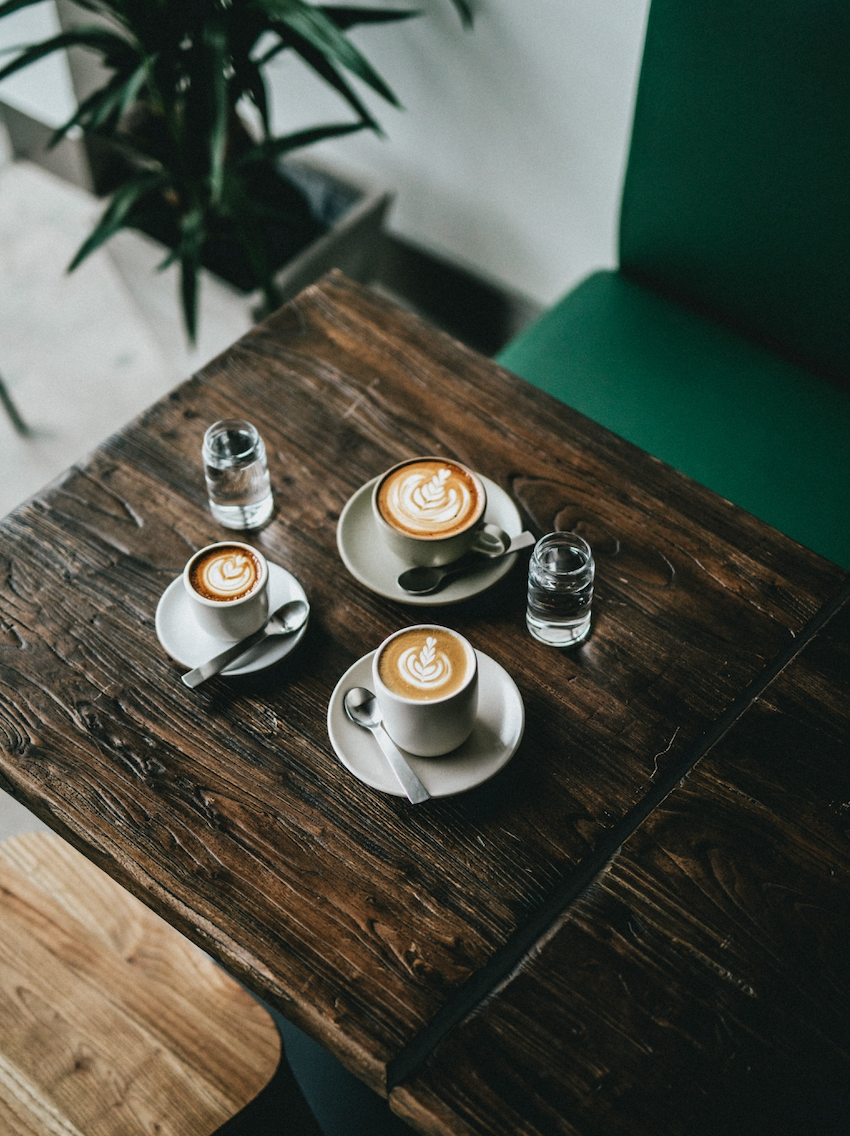 Coffee cups on a wooden café table.
