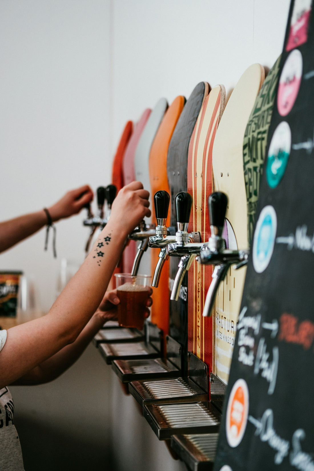 Workers filling up a glasses of beer at a brewery