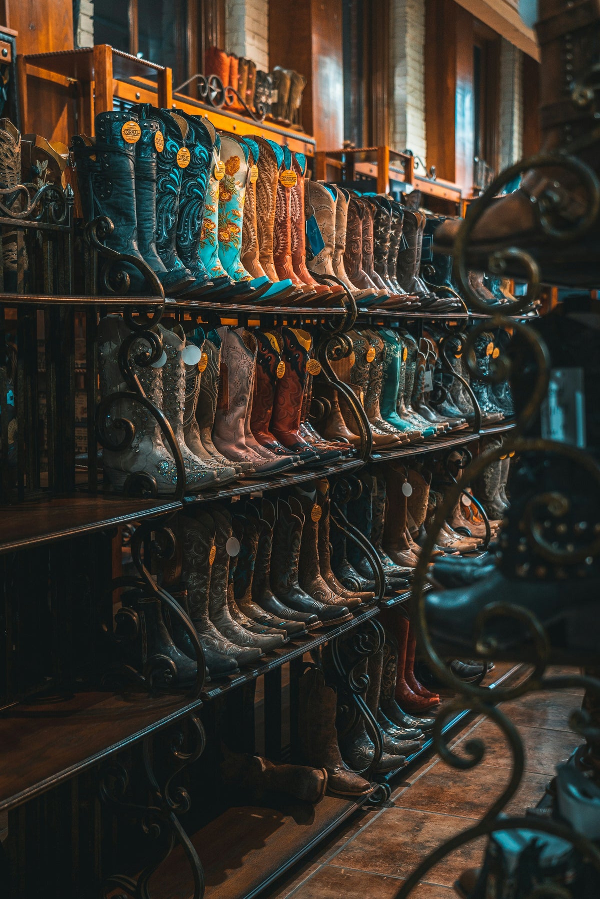 Rows of cowboy boots on display in a western shop.
