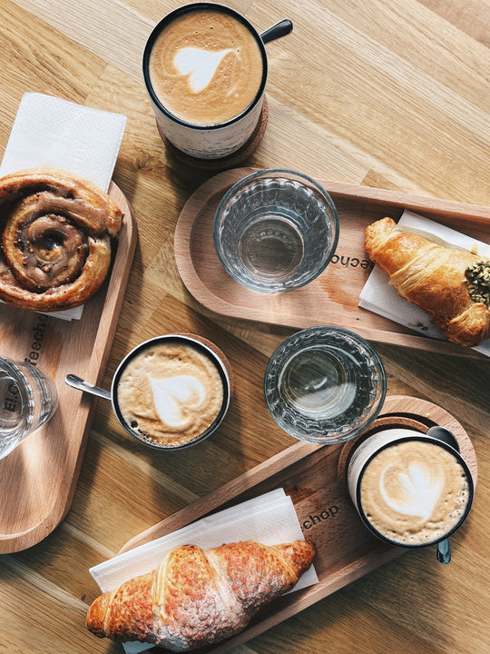 Table spread of coffee and sweet treats.