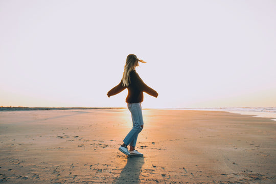 Woman spinning on the beach.