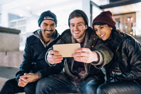 Three friends taking a selfie on a mobile phone
