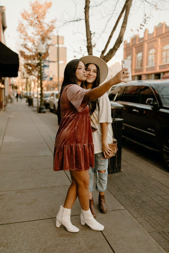 Two women taking a selfie on the street