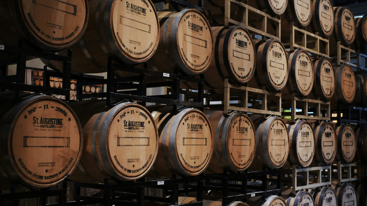 Wine barrels stacked in a cellar.