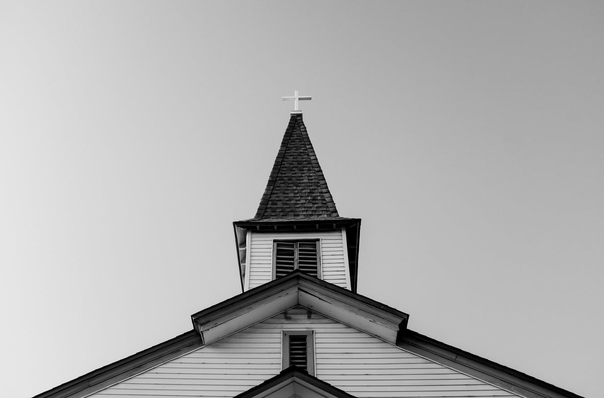 Black and white photo of a church steeple.