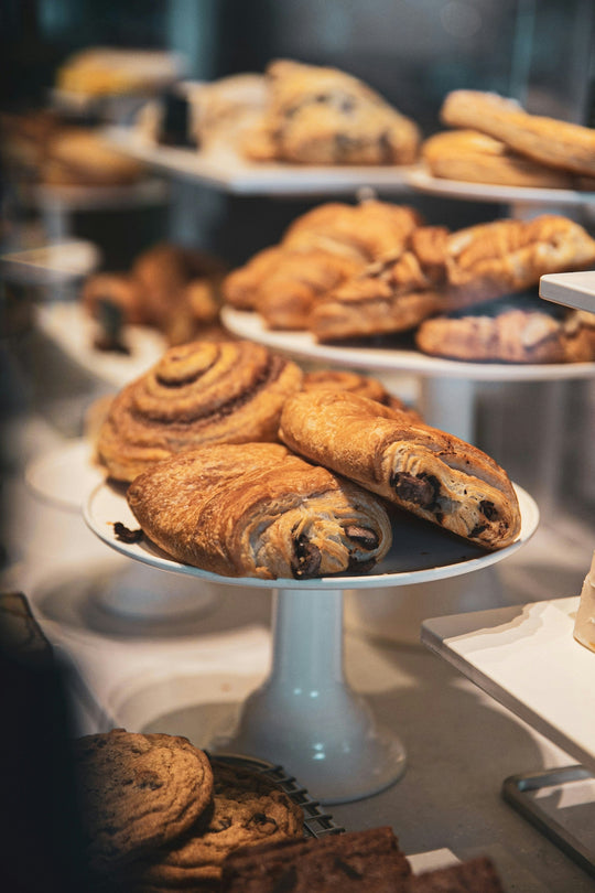 Bakery display with Pain au Chocolate and Cinnamon Rolls.