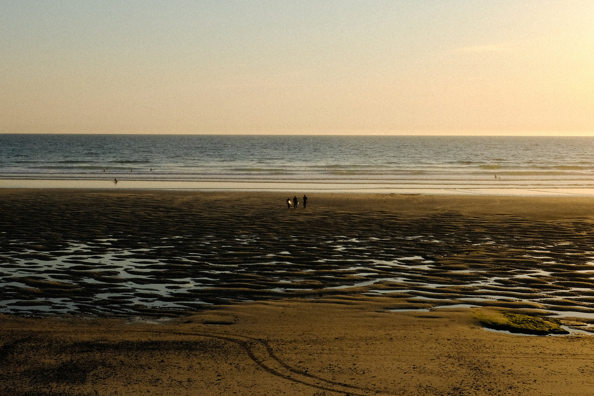 Low tide on a beach at sunset.
