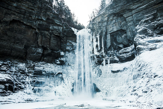 Frozen waterfall in a rocky landscape with snow