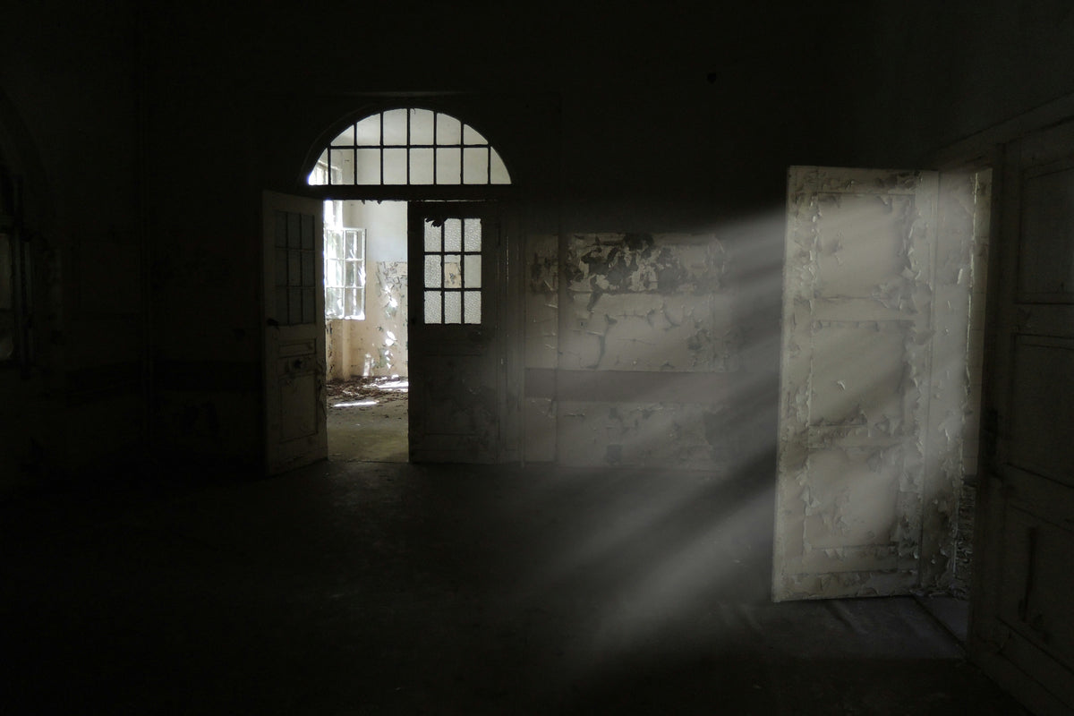 Light streaming into a dark, abandoned room.