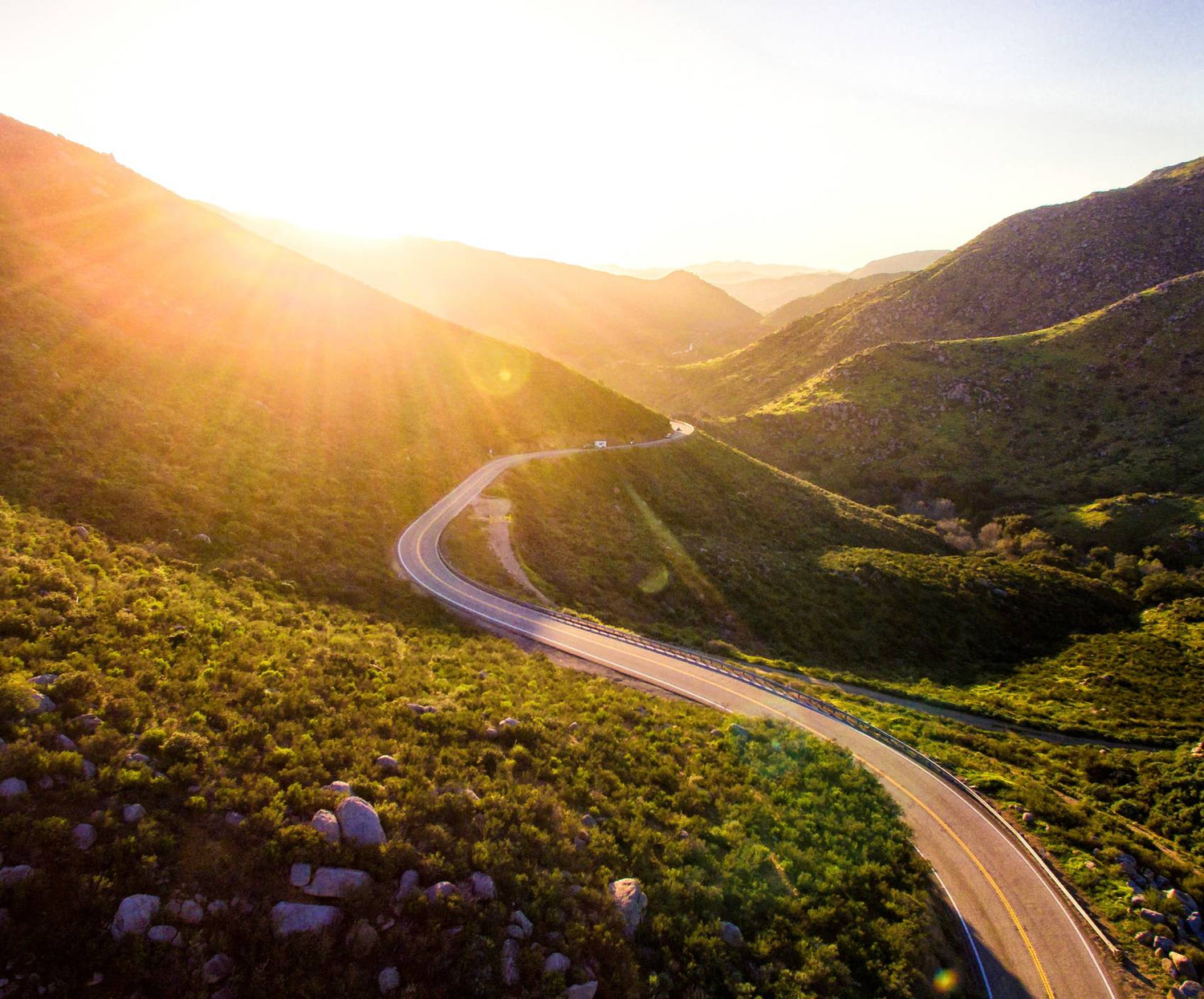 Winding roads through mountains at sunrise