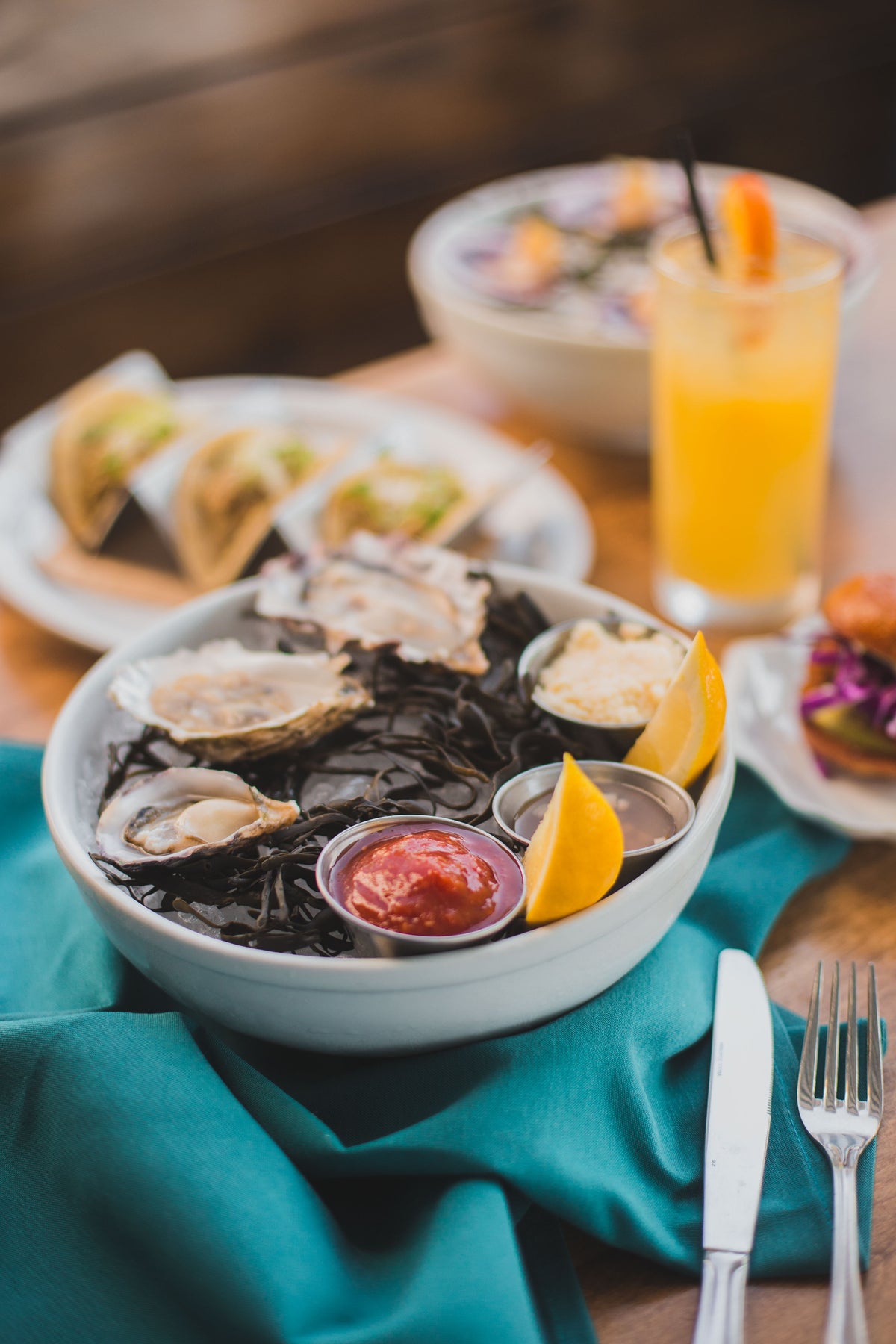 Oysters and a cocktail on a seaside table.
