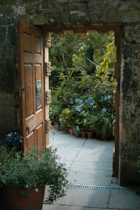 Doorway opening into a lush garden