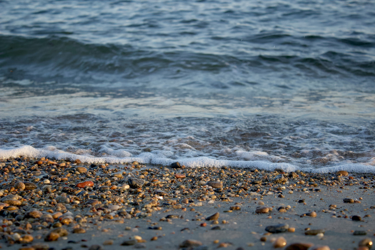 Pebbly beach with water.