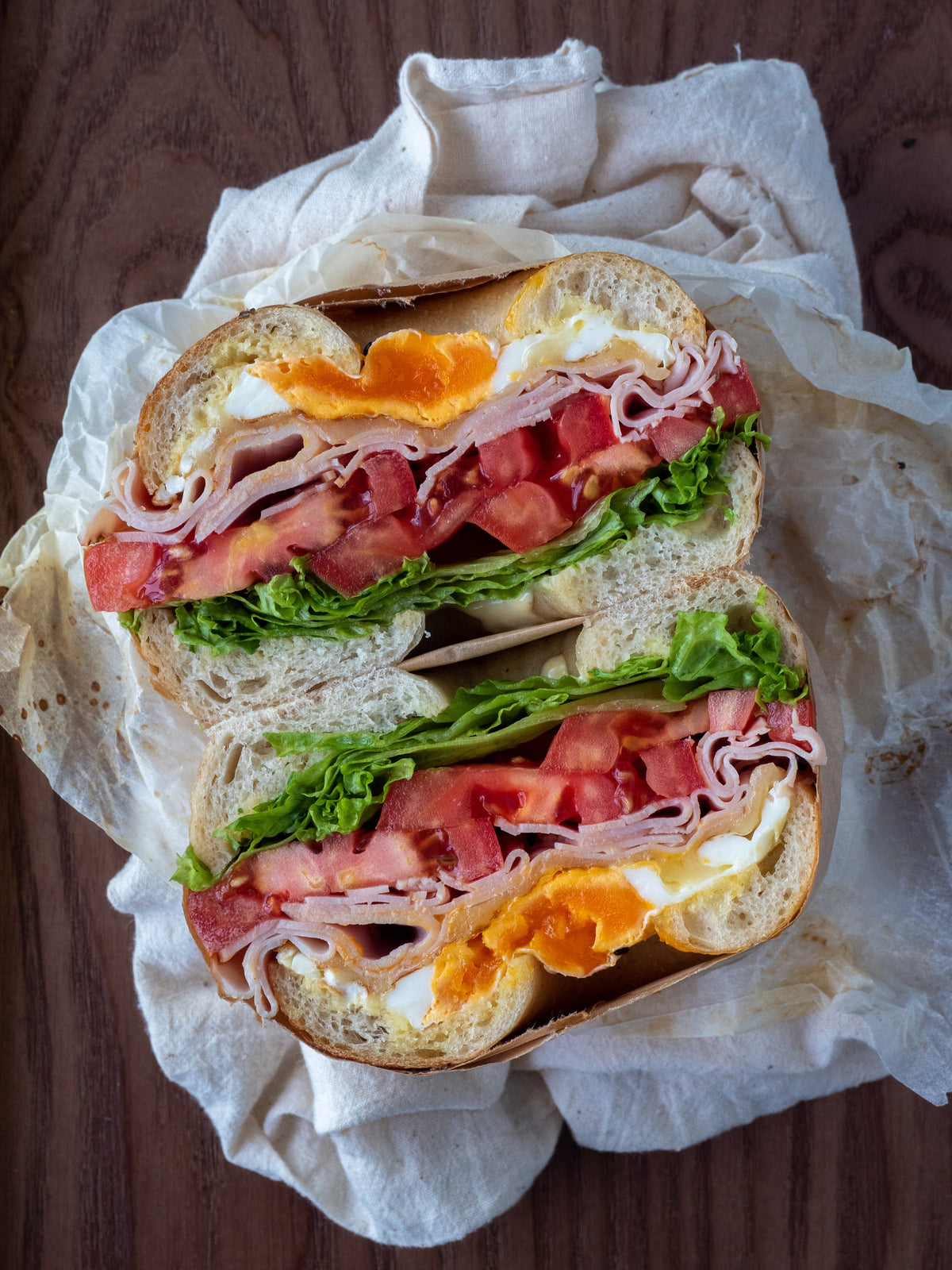 A breakfast sandwich wrapped in paper.