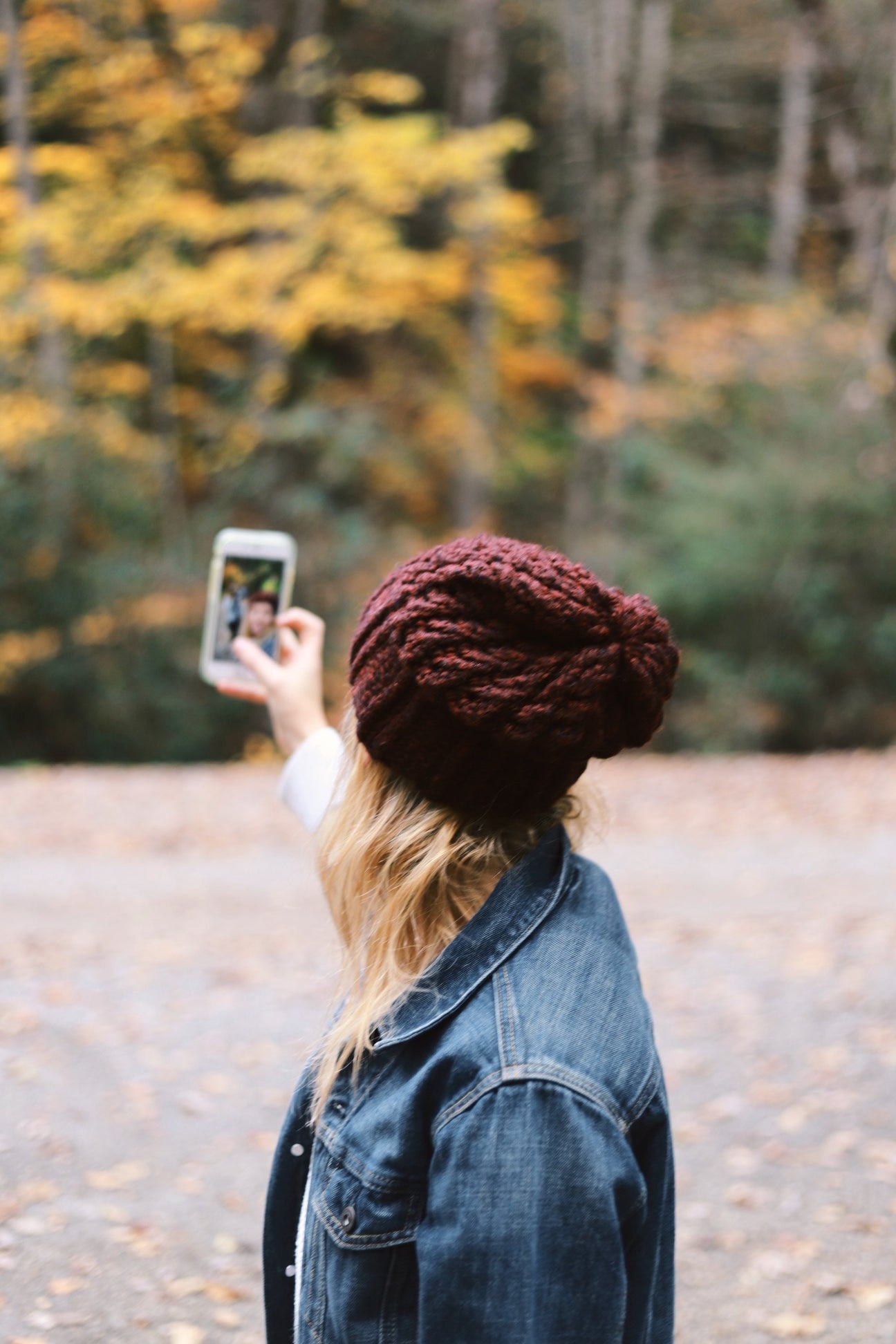Woman taking selfie outside