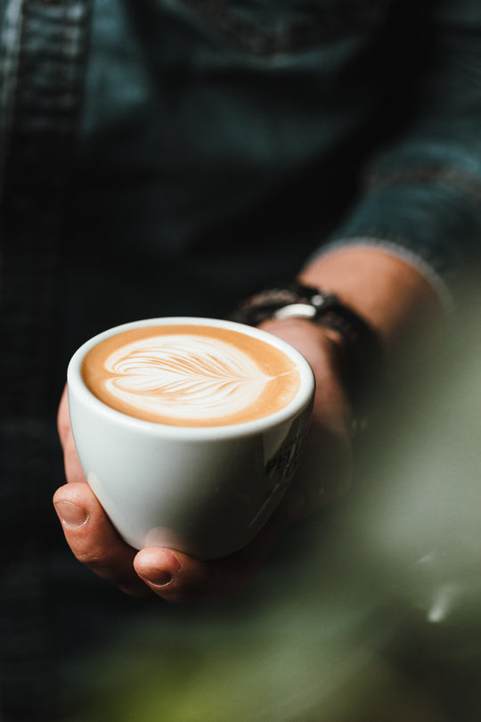 Man presenting latte.
