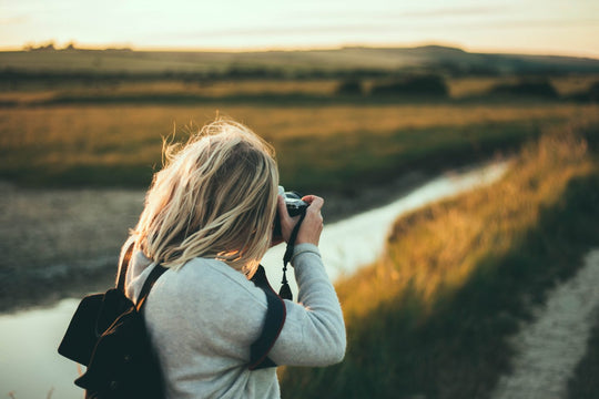 Woman taking a photo outdoors.