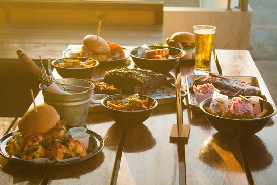 Table filled with different meals and beer.