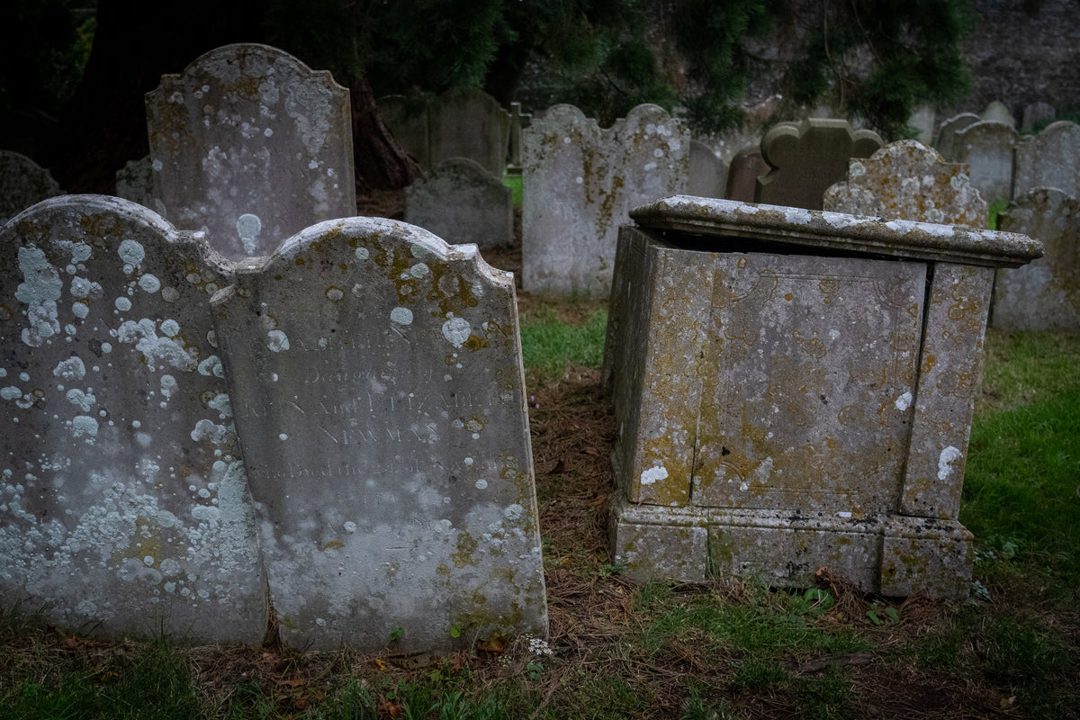 Weathered gravestones in an old cemetery.
