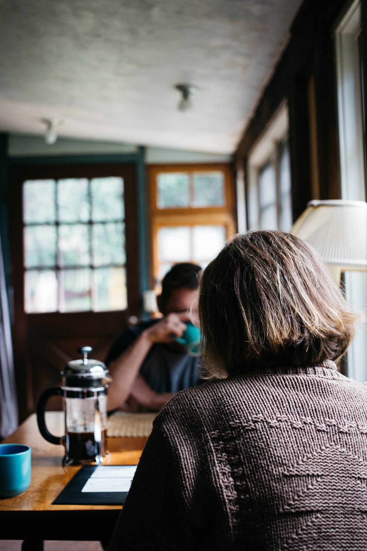 A woman sitting at a table in a cozy café.