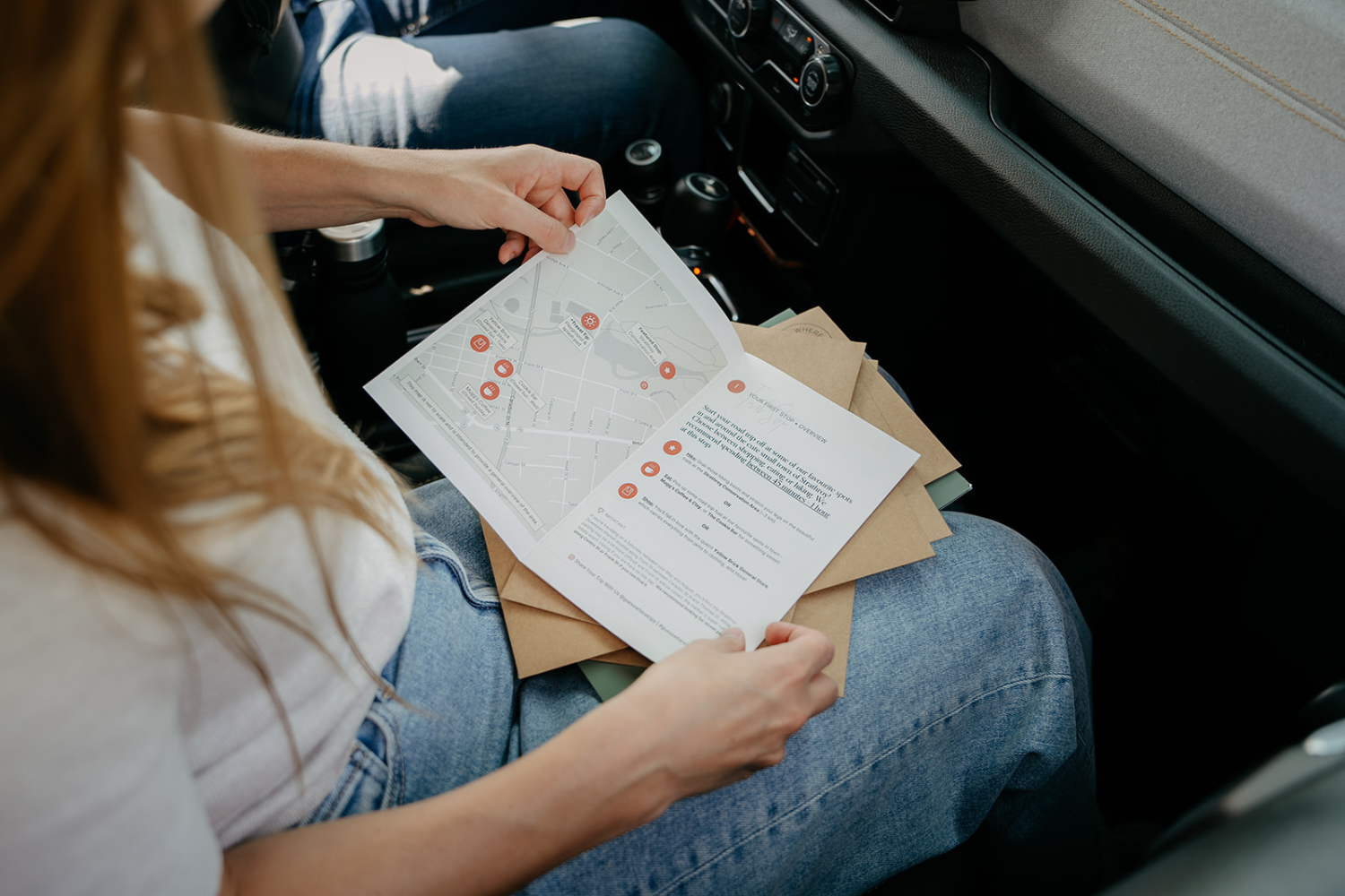 Hannah in car reading itinerary