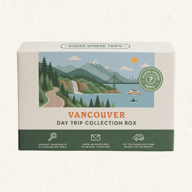 Vancouver Day Trip Box by Guess Where Trips, illustrated with mountains, evergreen forest, a waterfall, a suspension bridge and a ferry.