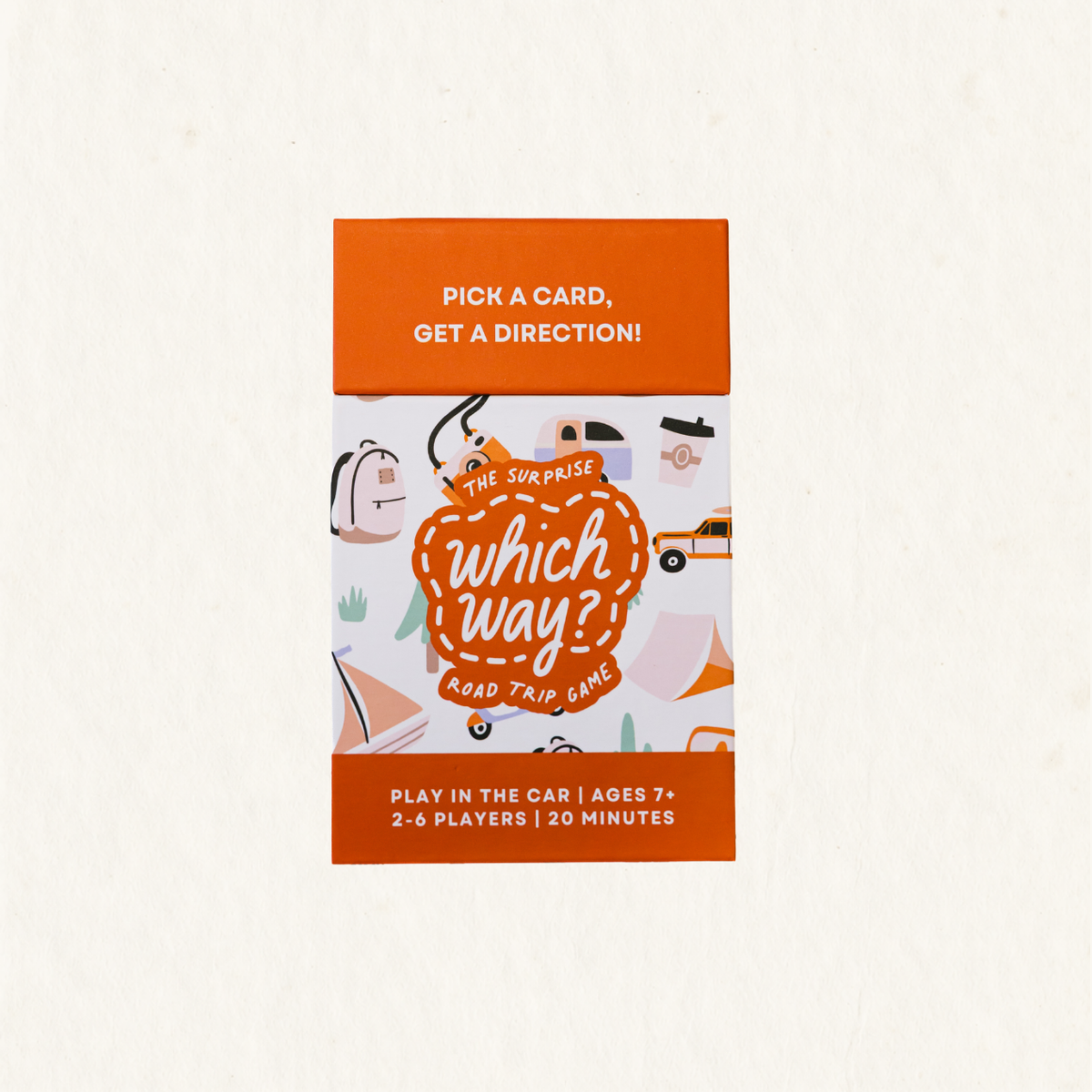 The Surprise Which Way? Road Trip Game box on a light cream textured background. The packaging features a bright orange top and bottom band with white text, and a central white panel decorated with cute illustrations of cars, a backpack, a coffee cup, and a suitcase, all framed by a dashed orange border.