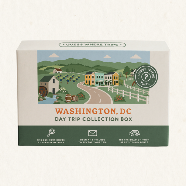 Washington DC Day Trip Box by Guess Where Trips, illustrated with rolling countryside, a farmhouse, colourful row houses, vineyards and a horse fence.