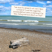A beach scene with ocean waves, blue sky, and a large driftwood log in the foreground, with a cream-colored text bubble overlaid containing a customer review quote.