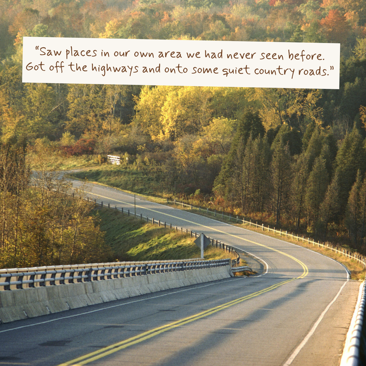 A winding country road through autumn forest with trees in yellow, green, and orange tones. A white text box near the top reads, “Saw places in our own area we had never seen before.