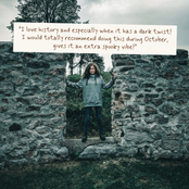 A woman stands in a stone ruin doorway outdoors under an overcast sky, with a large white text box overlaid at the top containing a spooky quote about October and a dark twist.