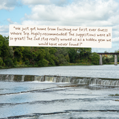 A scenic photograph of a river with a small waterfall, green trees, and a bridge under a cloudy blue sky, with a white text overlay containing a customer review.