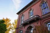 Historic red brick building in front of a blue sky