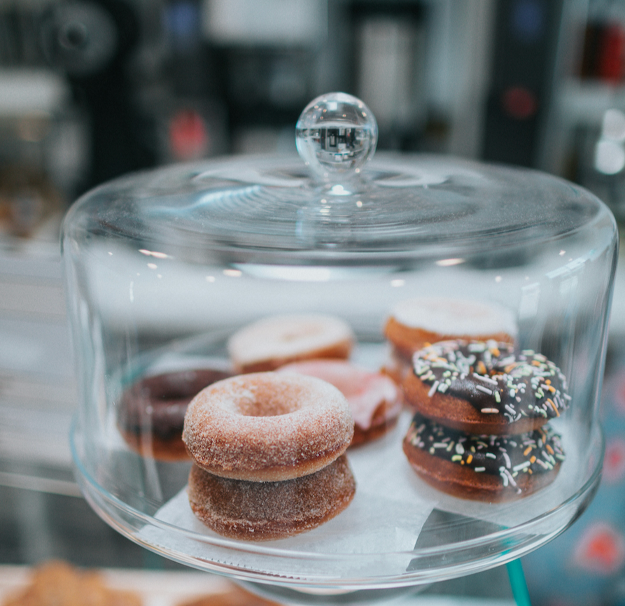 Donuts in a glass cloche.