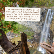 A scenic outdoor photograph of a waterfall in a forest, with a beige paper quote card overlaid near the top center. The quote reads: 'The surprise element made the day feel exciting from start to finish.