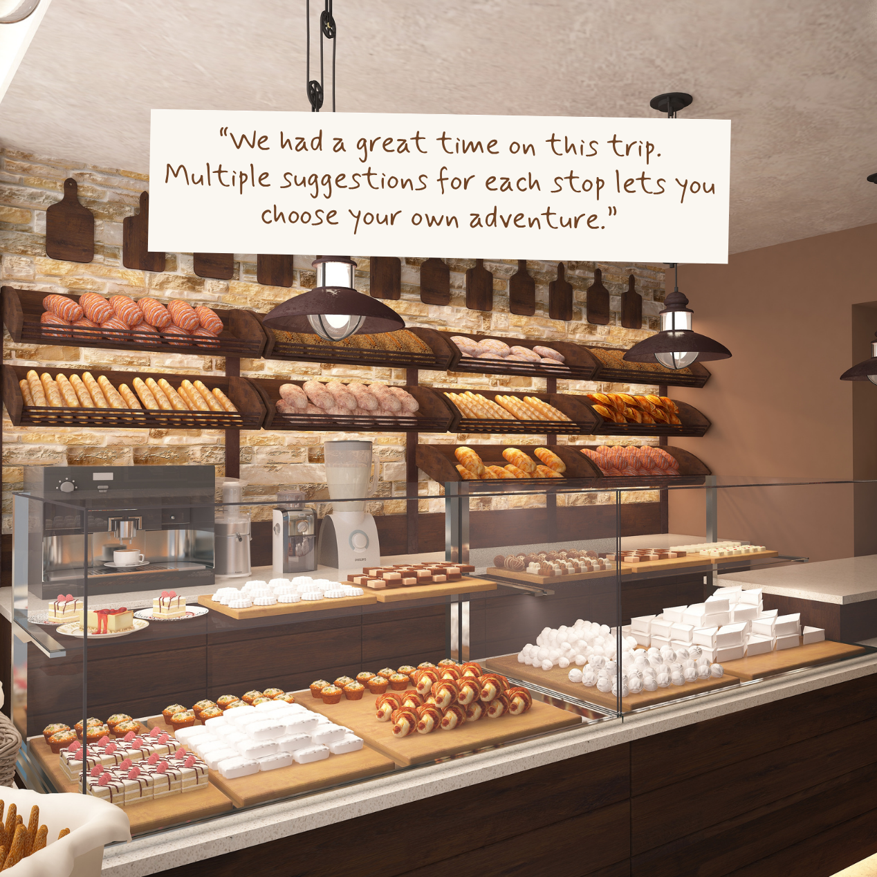 A bakery interior with shelves and glass display cases filled with pastries, breads, cakes, and pastries. A large white sign with brown text hangs from the ceiling, reading: 'We had a great time on this trip.