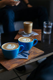 Two cappuccinos on a table in cafe