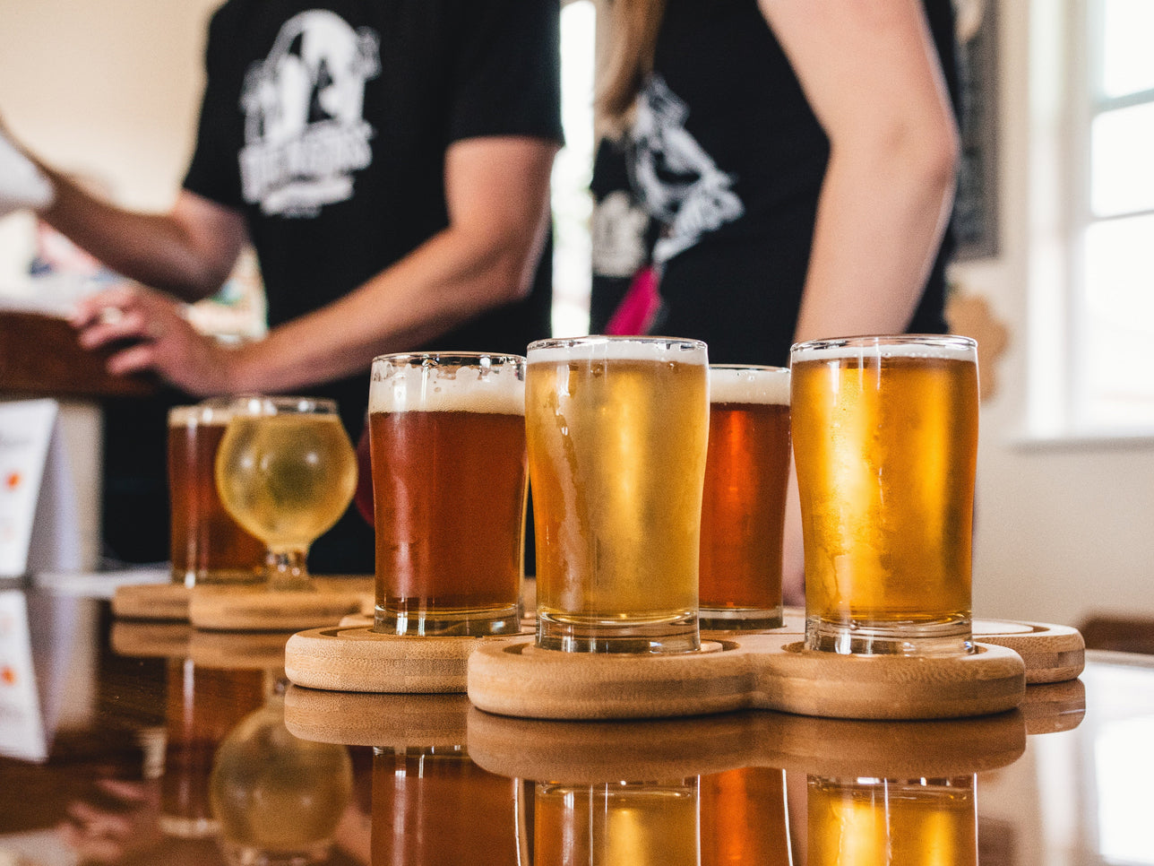 Beers on coasters at a brewery.