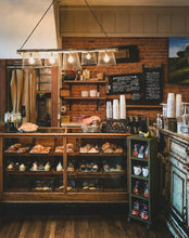 Interior of cafe with a baked goods on display.