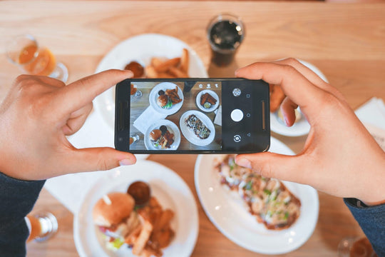 Photo of a photo of food being taken from a phone.