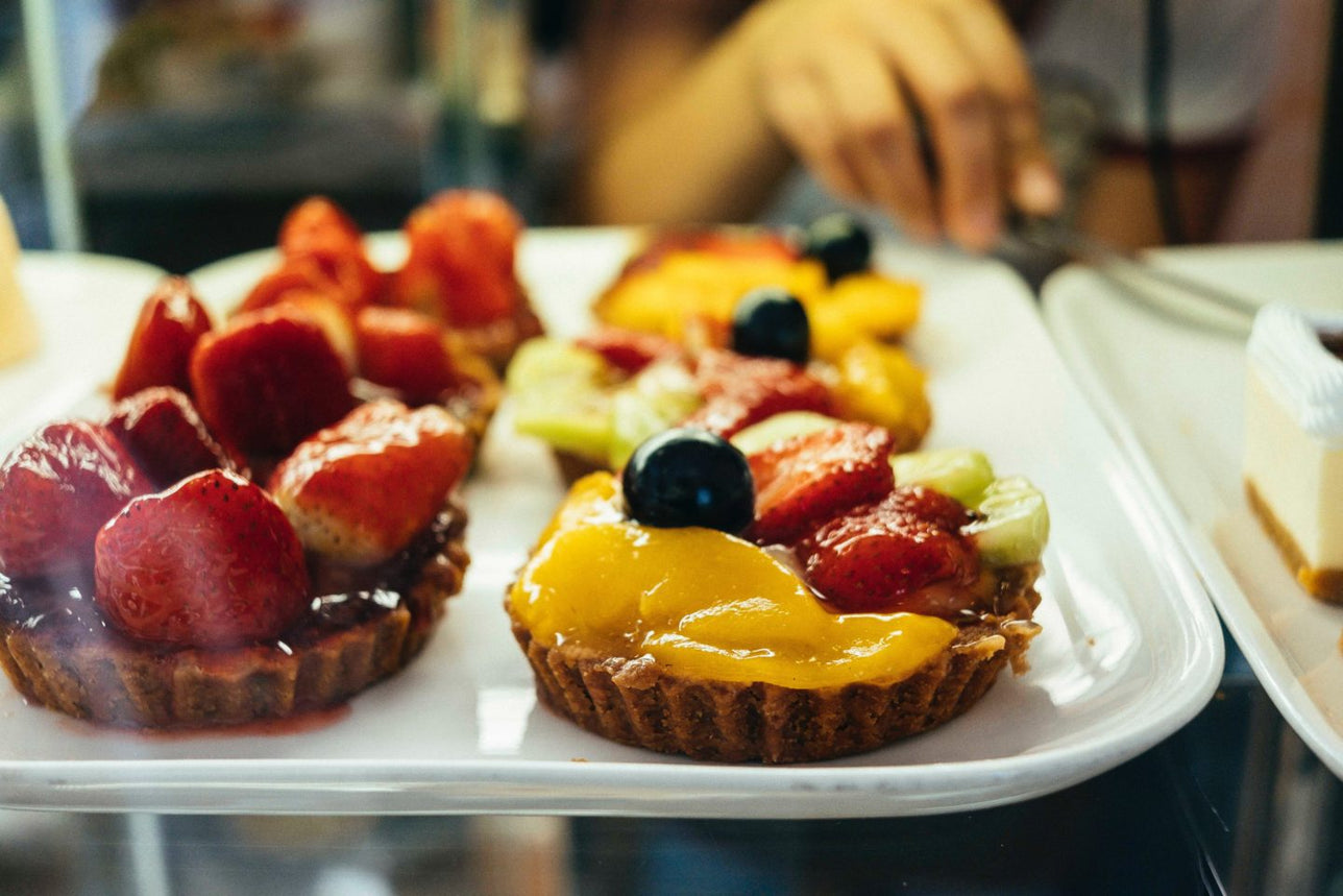 Close up of fruit tarts at a bakery.