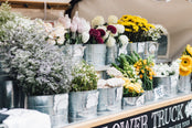 Flower truck with seasonal flowers displayed.