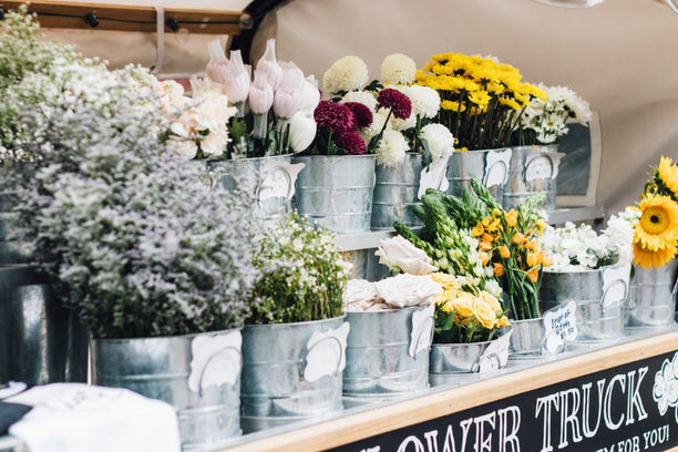 Flower truck with seasonal flowers displayed.