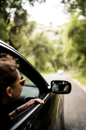 Woman looking out of car window.